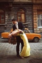 Groom leans over a bride in yellow dress Royalty Free Stock Photo