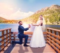 Groom makes a proposal of marriage on the pier