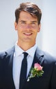 Groom man, portrait and outdoor at wedding in suit, rose and happy for celebration, event or party. Person, smile and Royalty Free Stock Photo