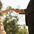 Groom marrying his bride outdoors in a park