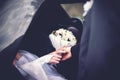 Groom meets bride from the car with wedding bouquet of flowers Royalty Free Stock Photo