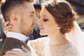 Groom in modern suit and bride in charming pink dress pose on the terasse with great mountain view in Georgia Royalty Free Stock Photo