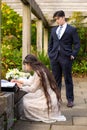 Groom in navy suit watching bride sign wedding certificate outdoors Royalty Free Stock Photo
