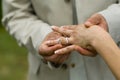 Groom placing engagement ring