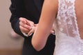 Groom placing wedding band on brides finger