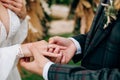 Groom plaid suit puts ring bride hand