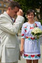 Groom prays,the bride with a bouquet looks at the groom who is baptized with his hand