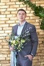 Groom preparing for the wedding. Future husband is waiting for his future wife.A man in a wedding suit poses for the photographer Royalty Free Stock Photo