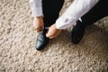 The man wears shoes. Tie the laces on the shoes. Men`s style. Royalty Free Stock Photo