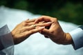 Groom put gold wedding ring on the bride`s finger, close-up. The wedding ceremony, exchange of rings Royalty Free Stock Photo