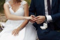 The groom puts a gold engagement ring on the finger of his bride Royalty Free Stock Photo
