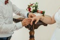 Groom puts a gold wedding ring on the bride`s finger Royalty Free Stock Photo