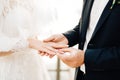 The groom puts the ring on the bride`s finger during the wedding ceremony