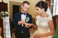 Groom puts a ring on delicate bride`s finger Royalty Free Stock Photo