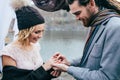 Groom puts a ring on the finger of the bride. Autumn wedding ceremony outdoors. Newlyweds with dreadlocks look at each Royalty Free Stock Photo
