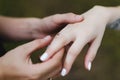 Groom puts the ring on the finger of the bride. Hands of groom and bride with rings Royalty Free Stock Photo