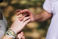 Groom puts the ring on the finger of the bride. Hands of groom and bride with rings. Wedding details Royalty Free Stock Photo