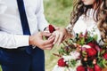 The groom puts the wedding ring on the bride finger. Wedding bouquet Royalty Free Stock Photo