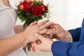 The groom puts a wedding ring on the bride finger. Wedding details Royalty Free Stock Photo