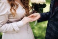 The groom puts a wedding ring on the bride`s finger Royalty Free Stock Photo