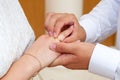 The groom puts the wedding ring on the bride`s finger at the wedding ceremony Royalty Free Stock Photo