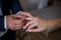 The groom puts the wedding ring on his finger Royalty Free Stock Photo