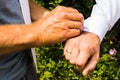 A groom putting on cuff-links as he gets dressed in his wedding day. Groom`s suit Royalty Free Stock Photo