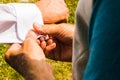 A groom putting on cuff-links as he gets dressed in his wedding day. Groom`s suit Royalty Free Stock Photo