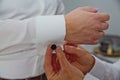 A groom putting on cuff-links. Groom's suit Royalty Free Stock Photo