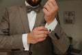 A groom putting on cuff-links. Groom's suit Royalty Free Stock Photo