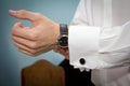 Groom putting on his cufflinks