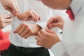 Groom putting on his cufflinks