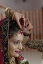 Groom putting Sindoor on Bride's forehead in Indian Hindu wedding. Royalty Free Stock Photo