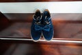 Groom`s blue suede shoes and bow