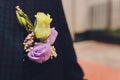 Groom`s boutonniere on a jacket of dark blue color. The wedding boutonniere consists of a pink rose, a small dianthus Royalty Free Stock Photo