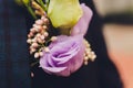 Groom`s boutonniere on a jacket of dark blue color. The wedding boutonniere consists of a pink rose, a small dianthus Royalty Free Stock Photo