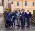 The groom`s friends hold him in front of the church in the Small Square. Sibiu city in Romania