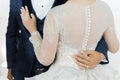 The groom's hand hugs the bride's waist in wedding ceramony. Royalty Free Stock Photo