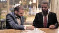 The groom signs the ketubah