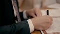 A groom signs a ketubah on a wedding day