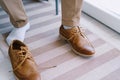 Groom sits on a chair in unlaced shoes. Close-up Royalty Free Stock Photo