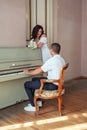 The groom sits at the piano and plays cheerful melody Royalty Free Stock Photo