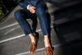 A groom is sitting at the steps. He is wearing a blue suit and a brown shoes Royalty Free Stock Photo