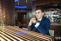 Groom sitting at the table in a bar and waiting for his bride Royalty Free Stock Photo