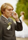 Groom speaks by phone , forgotten about bride Royalty Free Stock Photo