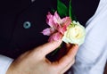 The groom straightens the buttonhole, close-up Royalty Free Stock Photo