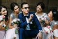 Groom in the sunglasses surrounded by charming bridesmaids