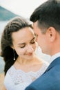 Groom tilted his face to the face of the smiling bride. Portrait Royalty Free Stock Photo
