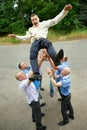 Groom tossed by a group of groomsmen