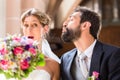 Groom trying to kiss bride in church